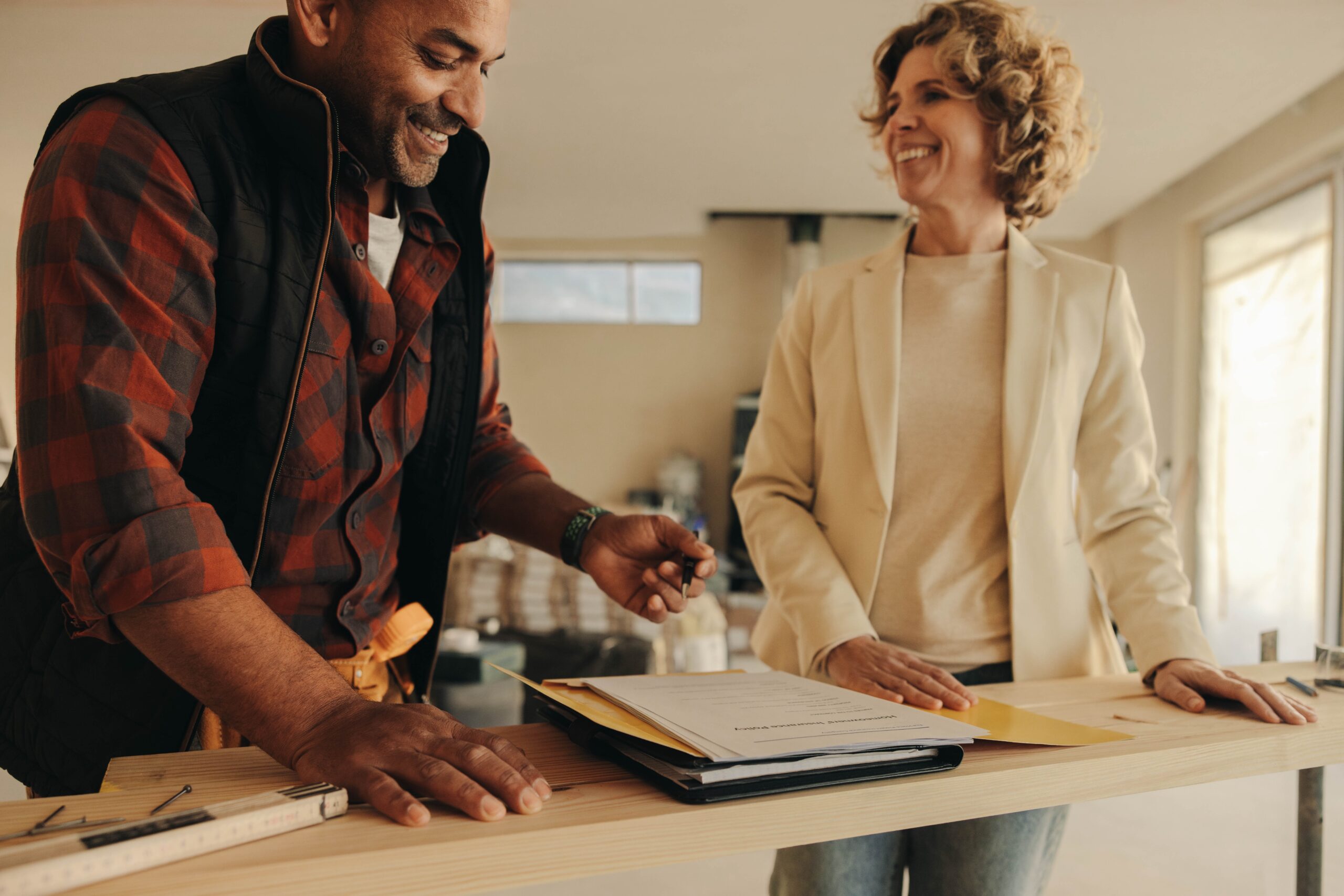 Couple reviewing paperwork together at a kitchen counter